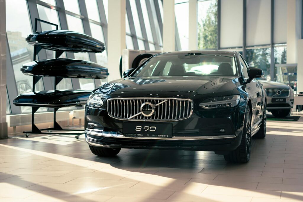 Elegant Volvo S90 on display in a modern car showroom with bright lighting and contemporary design.