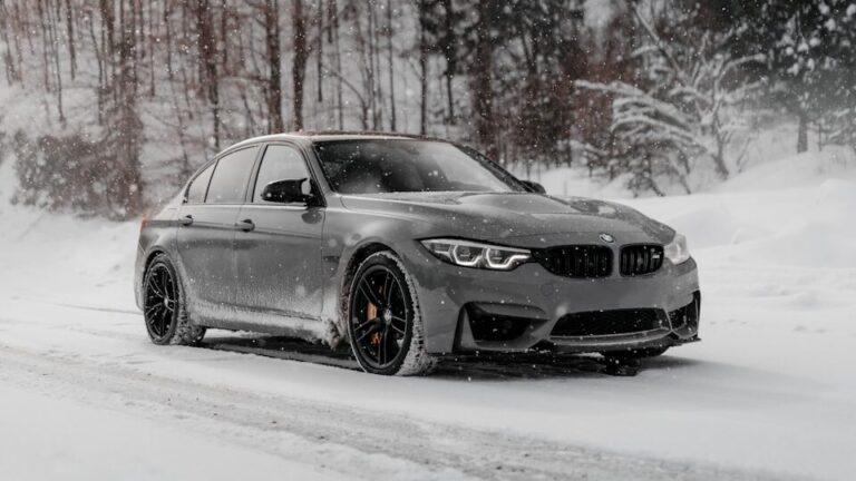 black bmw coupe on snow covered road during daytime